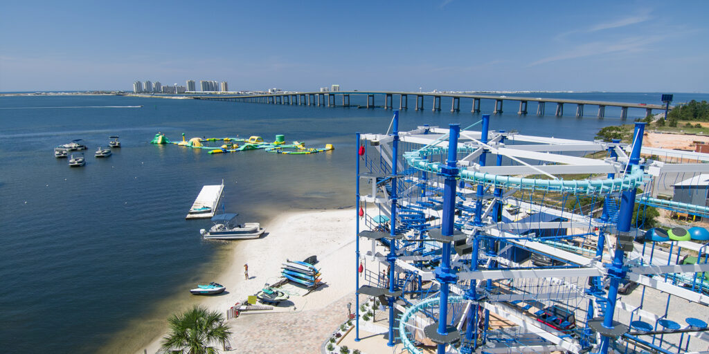 Aerial photo of ropes course and zip line overlooking the Santa Rosa Sound and Navarre Bridge