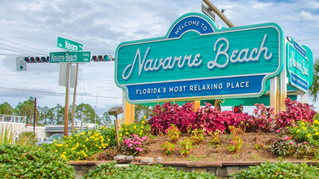 A welcome sign at the foot of the Navarre Beach Bridge. Florida’s most relaxing place.