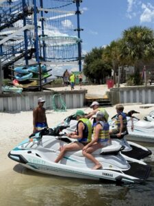 Photo of Waverunner with family on it being briefed by a Navarre Family Watersports team member